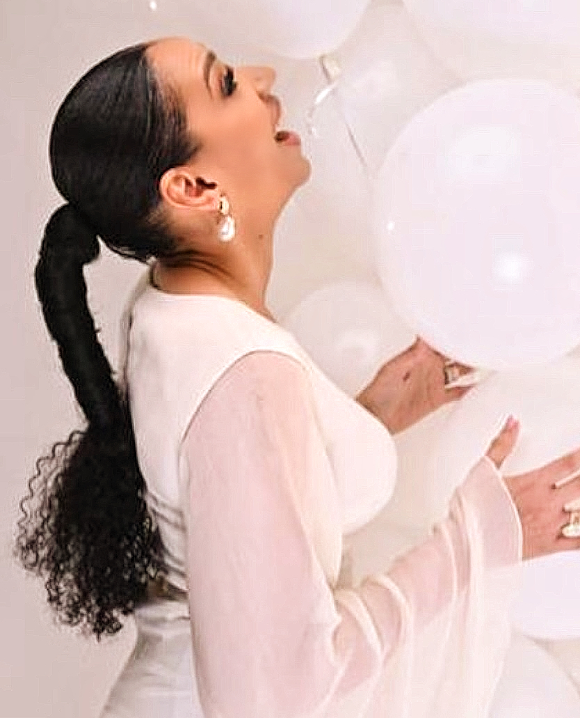 Sleek ponytail with curled ends